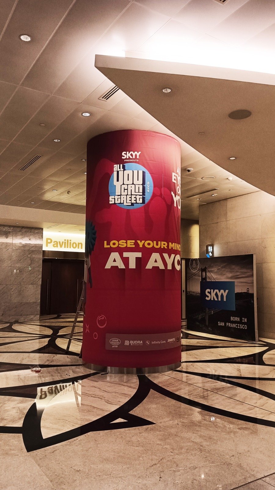Fabric Pillar Wrap — Seamless fabric pillar branding installed in a venue concourse.